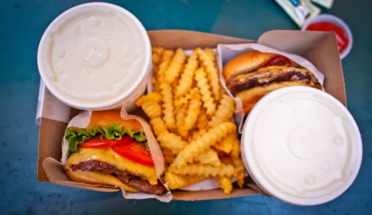 overview of fried food like fries, burgers and shakes