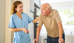 nurse and senior man smiling at each other