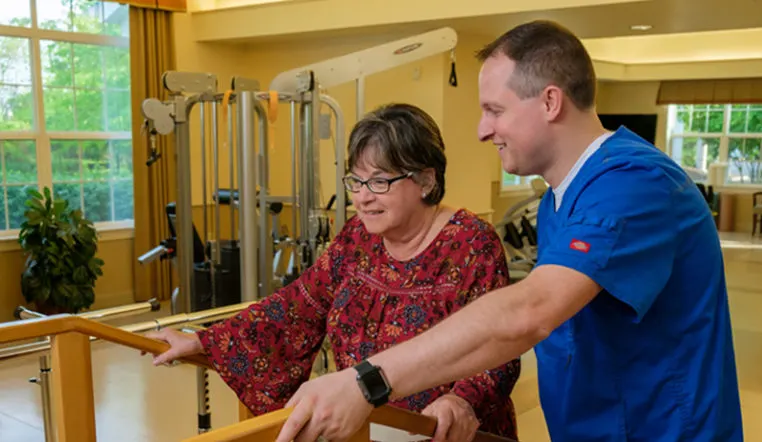 senior woman using rehab equipment