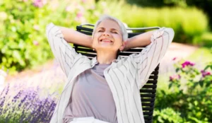 lady sitting on chair outside happy