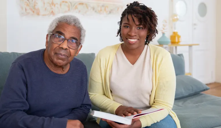senior man and daughter looking at camera