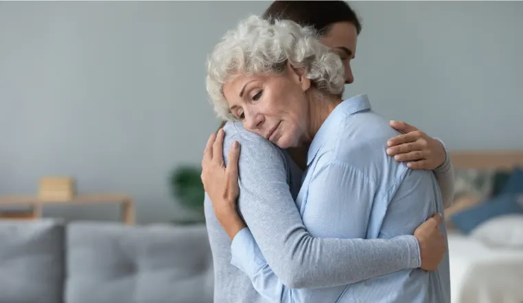 senior and daughter hugging